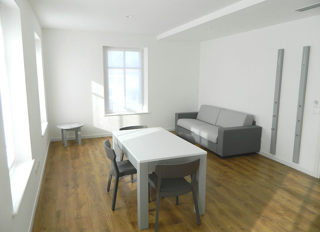 Living room with dining area of the Deluxe 60 sqm apartment, Palamostre Residence, Udine